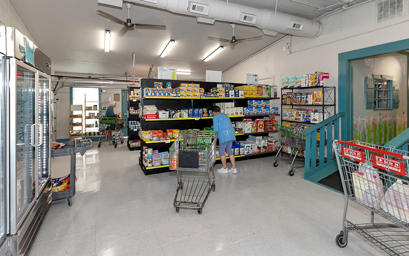 Shoppers picking items from shelves in a pantry setting